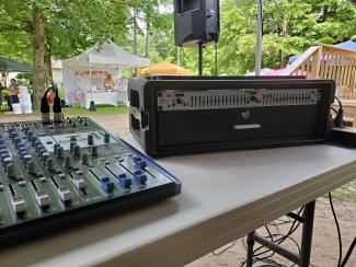 PreSonus AR12c mixer (left) and dbx dual 15 band EQ with mic drawer (right) Mackie Thumps on K&M stands. Rise & Ride Open Ranch 2022